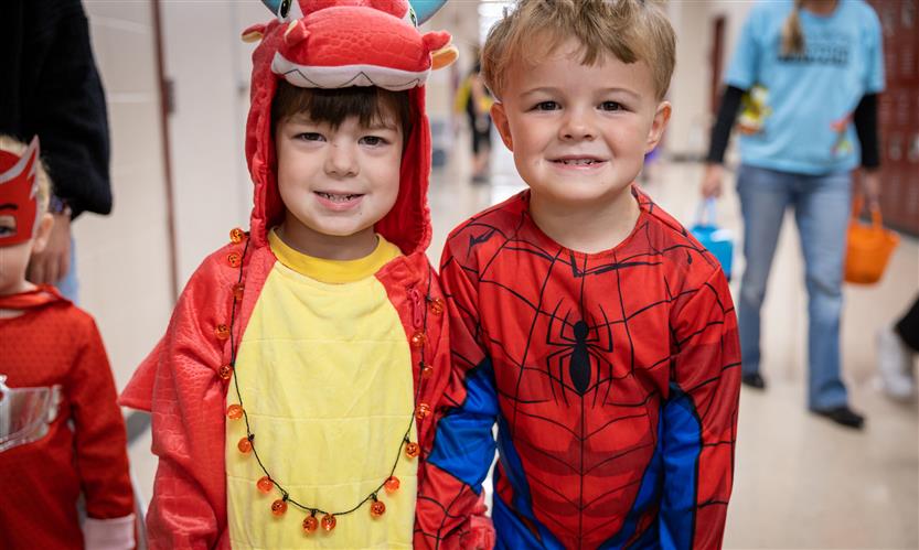 Children in costume trick or treat around school